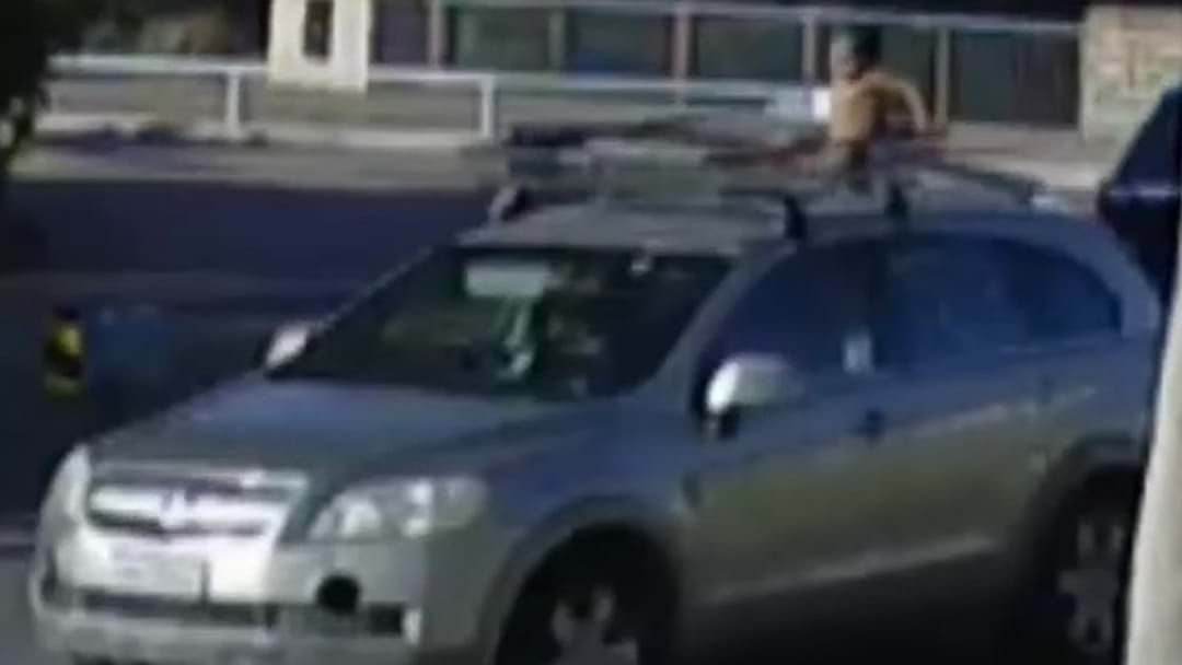 Article heading image for Footage Emerges Showing A Toddler Riding On The Roof Of Car As His Mother Drives Unaware