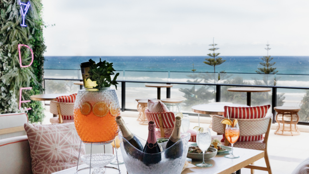 Article heading image for This Mammoth Beachside Champagne & Spritz Brunch Exists & Yes You'll Need Your Stretchy Pants!