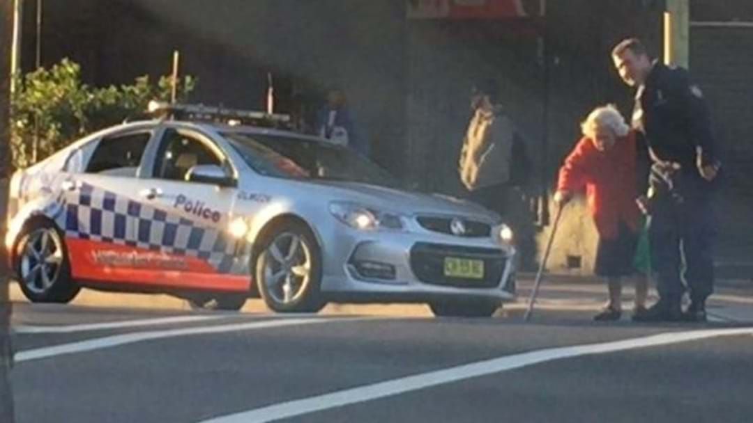 Article heading image for Police Officer Stops Sydney Peak Hour Traffic To Help Elderly Woman Cross Road