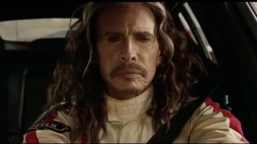 Article heading image for WATCH: Aerosmith’s Steven Tyler Race F1 Champion In Car Commercial
