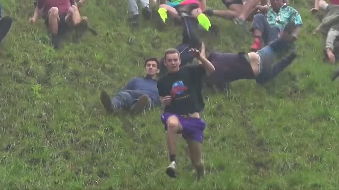 Article heading image for Please Enjoy This Video Of People Absolutely Stacking It At This Year's Cheese Rolling Championships