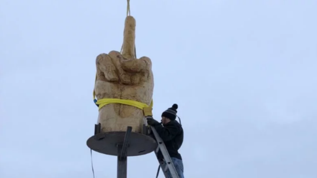 Article heading image for Angry Resident Erects Giant Statue To Give His Entire Town The Middle Finger Salute