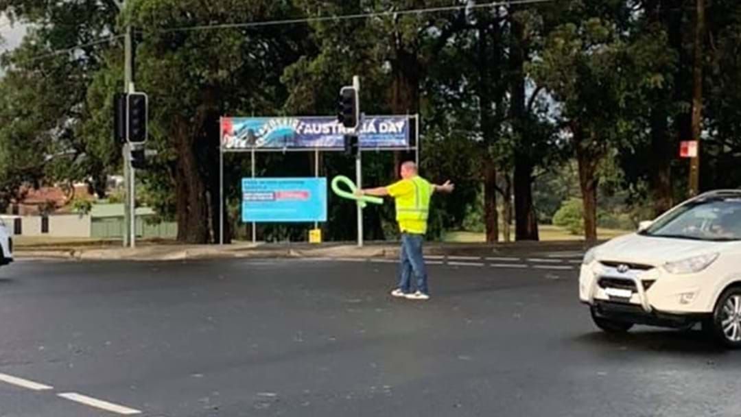 Article heading image for The Pool Noodle Man Directing Traffic During Sydney Storm Tells His Story