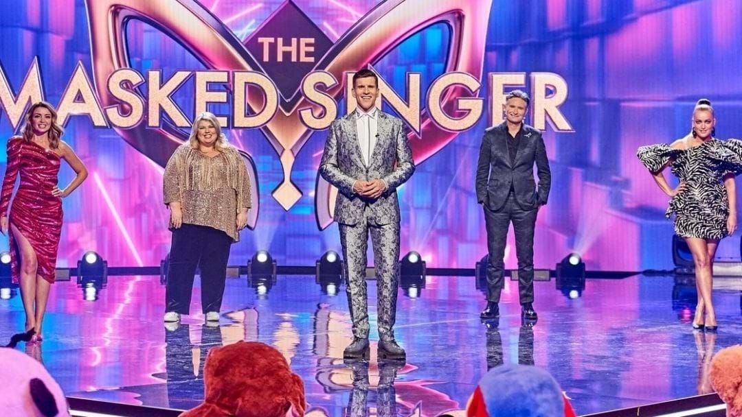 Article heading image for Ash Pollard Roasts The Masked Singer's Stylist To Hughesy's Face